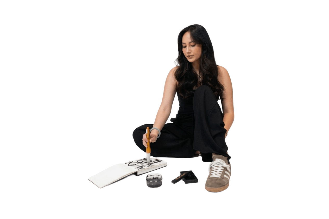 Ashley Vong sitting and drawing on a note block
