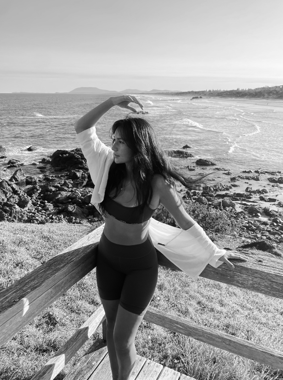 Ashley Vong standing at a fence at the beach